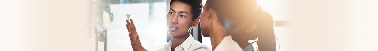 Group of three people talking and looking at notes